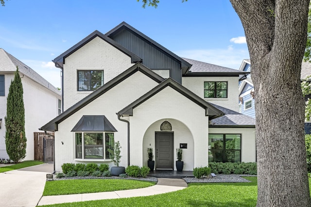 4527 Elsby Ave, Dallas, TX 75209 - view of front of home with brick siding, a front yard, and a shingled roof