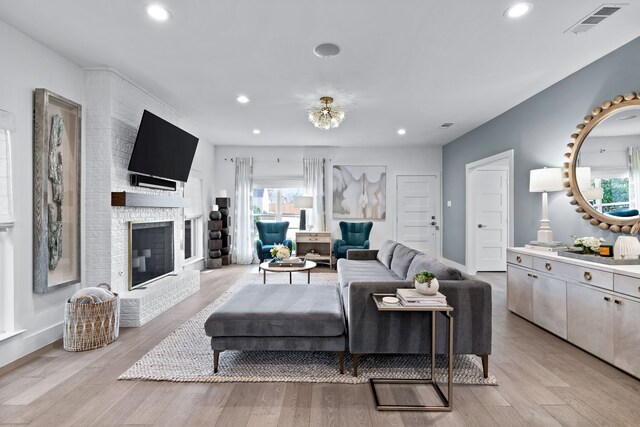 4527 Elsby Ave, Dallas, TX 75209 - living room with recessed lighting, light wood-style floors, and a brick fireplace