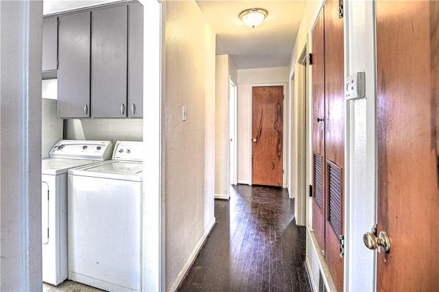 laundry room featuring washer and clothes dryer, wood finished floors, cabinet space, and baseboards