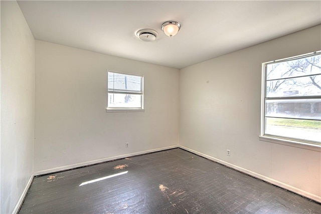 unfurnished room with baseboards and visible vents