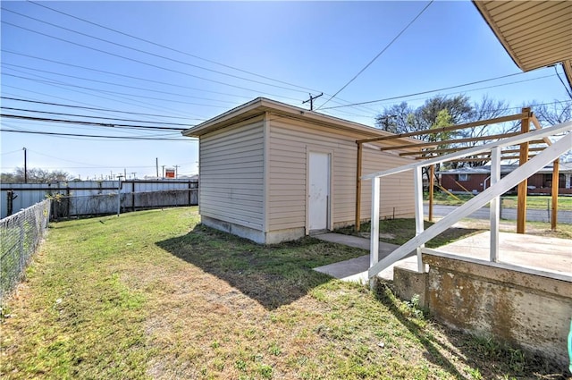 view of yard with a fenced backyard and an outbuilding