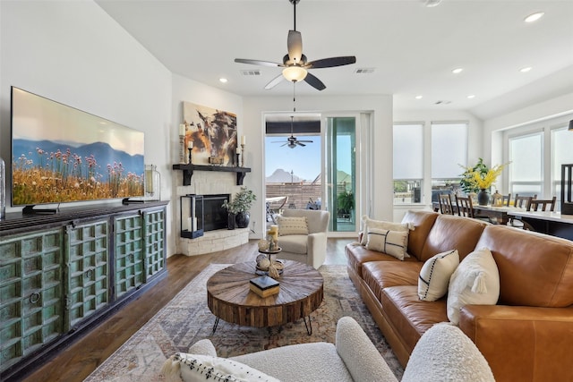 living area featuring a fireplace, wood finished floors, visible vents, ceiling fan, and recessed lighting