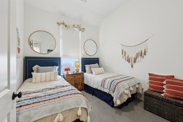 carpeted bedroom with lofted ceiling