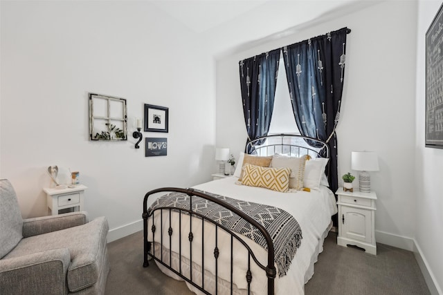 bedroom featuring baseboards and dark colored carpet