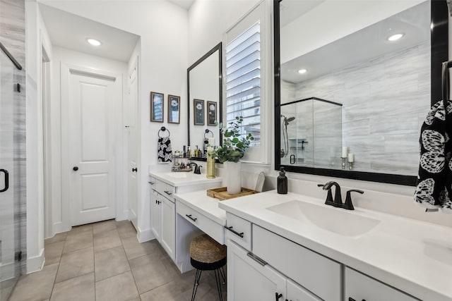 bathroom with tile patterned flooring, a sink, recessed lighting, and a shower stall