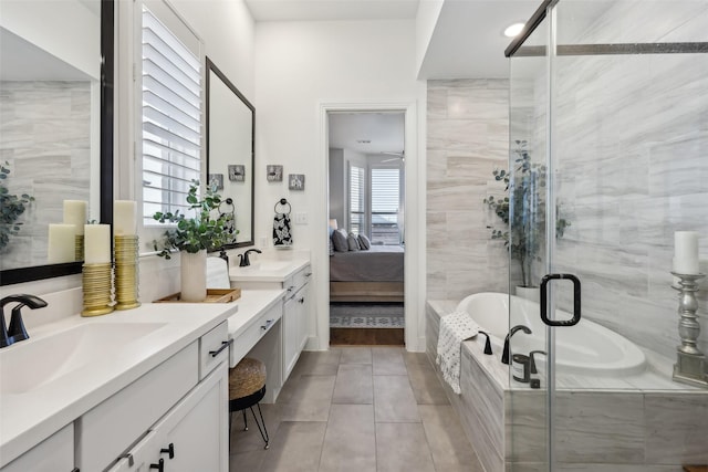 full bathroom featuring connected bathroom, vanity, a stall shower, and a bath