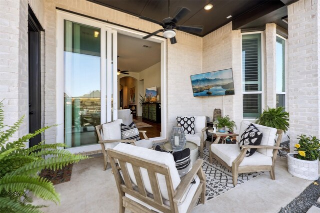 view of patio / terrace with an outdoor living space, visible vents, and a ceiling fan