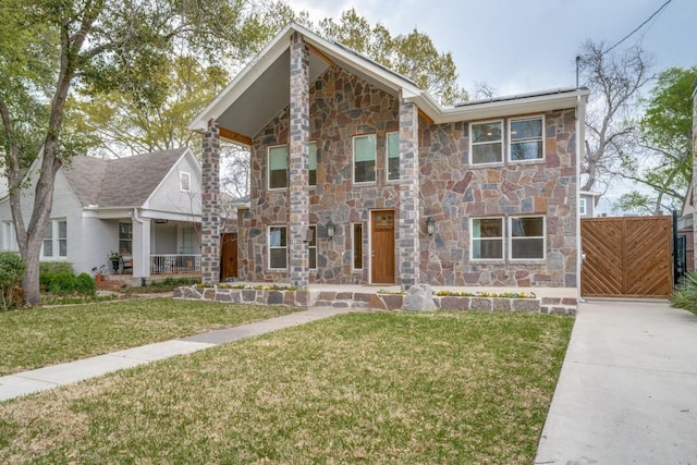 5120 Maple Springs Blvd, Dallas, TX 75235 - view of front of property with concrete driveway, stone siding, covered porch, fence, and a front yard