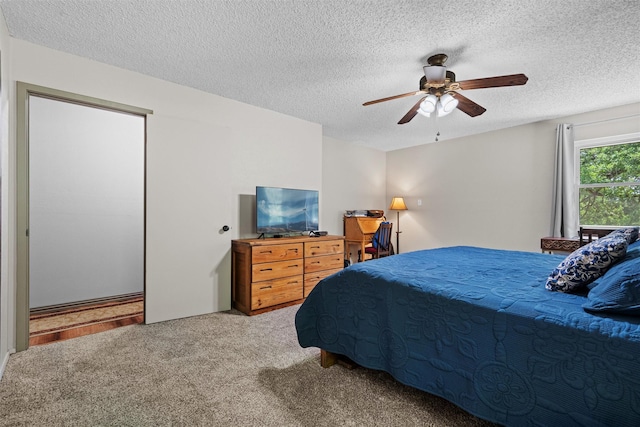 bedroom featuring a textured ceiling, ceiling fan, and carpet