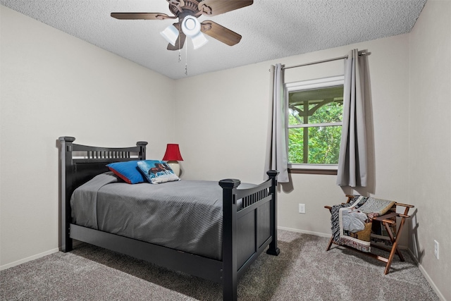 bedroom with carpet flooring, a textured ceiling, and baseboards