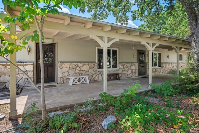 back of property with stone siding