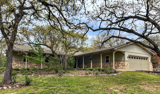 ranch-style home with stucco siding, a porch, stone siding, a front lawn, and a garage