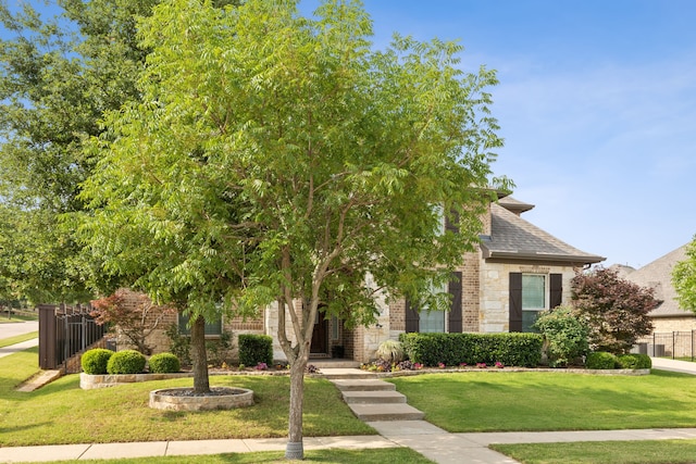 4924 Broiles Ct, Fort Worth, TX 76244 - view of property hidden behind natural elements featuring stone siding, a shingled roof, and brick siding
