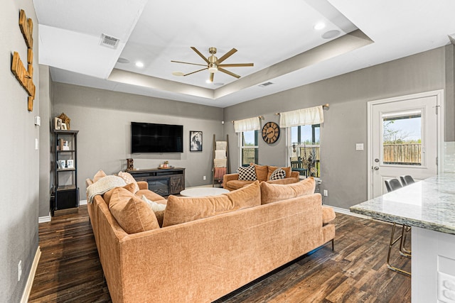 123 Oak Springs Loop, Mabank, TX 75147 - living room featuring a raised ceiling, a ceiling fan, dark wood-style flooring, baseboards, and recessed lighting
