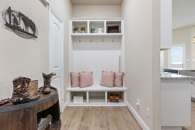 mudroom with baseboards and light wood-style floors