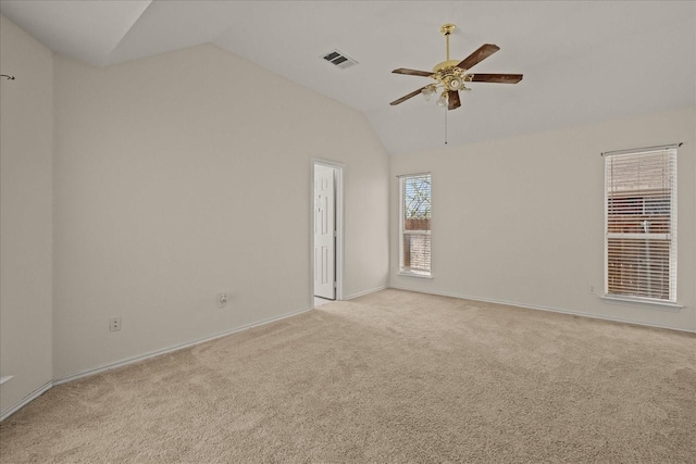 unfurnished room featuring vaulted ceiling, baseboards, visible vents, a ceiling fan, and light carpet