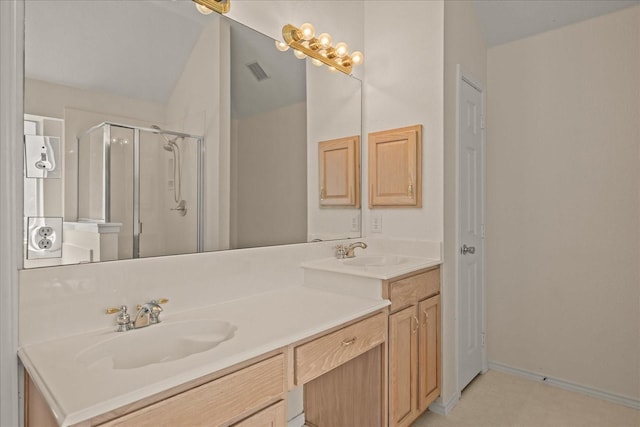 full bath with visible vents, a sink, a stall shower, and double vanity