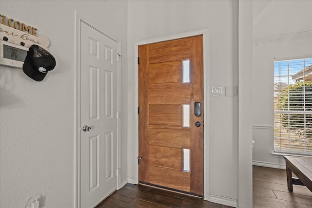entryway featuring baseboards and wood finish floors