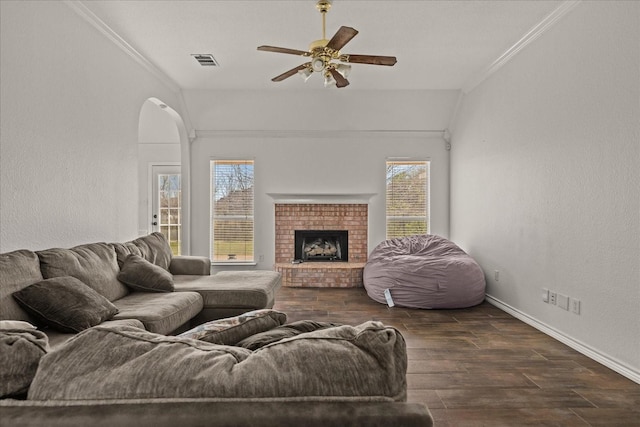 living area featuring visible vents, wood finished floors, ceiling fan, and ornamental molding