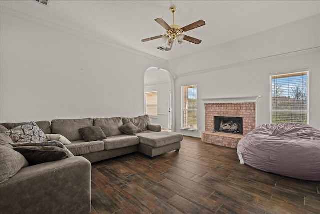 living area featuring visible vents, dark wood-style floors, a healthy amount of sunlight, and ceiling fan