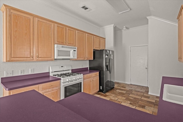 kitchen with visible vents, dark countertops, crown molding, and white appliances