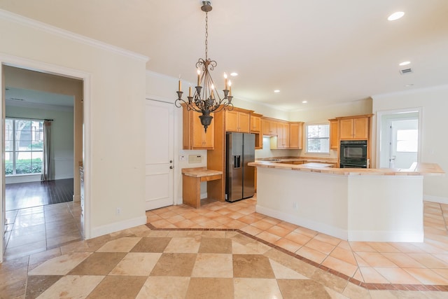 kitchen featuring light countertops, crown molding, stainless steel fridge, and recessed lighting