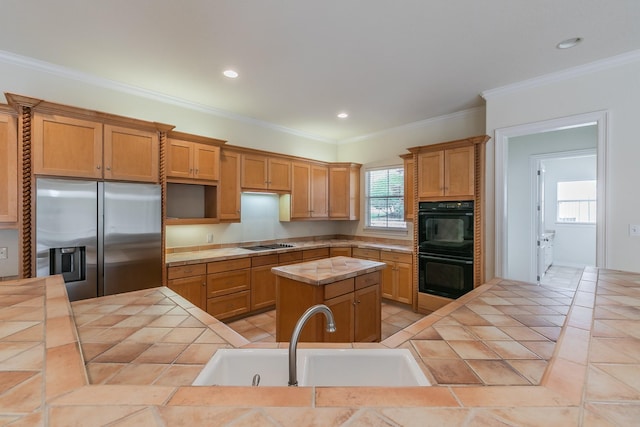 kitchen featuring recessed lighting, a sink, black appliances, a kitchen island, and tile countertops