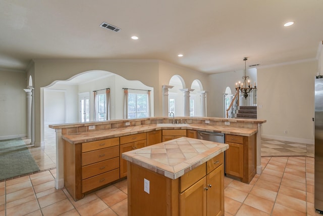 kitchen featuring a kitchen island, a notable chandelier, recessed lighting, and tile countertops