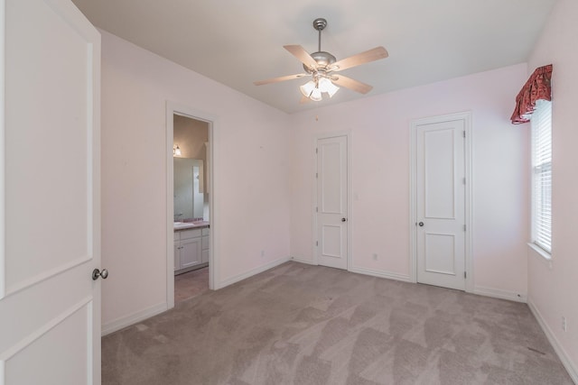 unfurnished bedroom with baseboards, light carpet, and multiple windows
