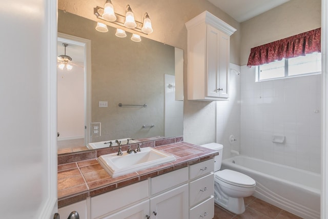 bathroom with vanity, ceiling fan, tile patterned floors, toilet, and tub / shower combination