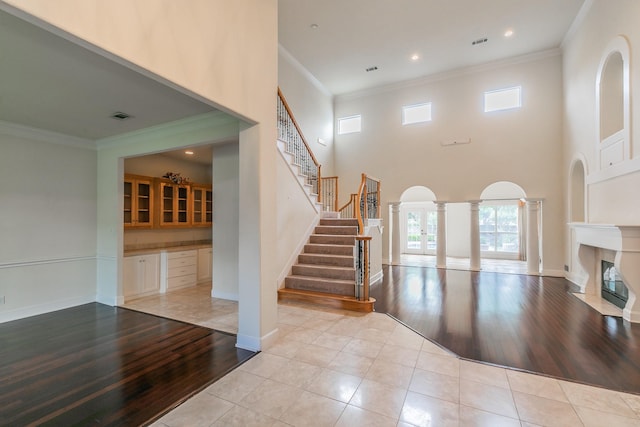 interior space with stairway, light wood-style floors, plenty of natural light, and visible vents