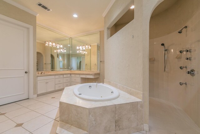 bathroom featuring visible vents, tile patterned floors, a walk in shower, a garden tub, and vanity