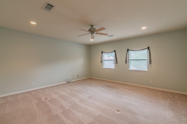 spare room with visible vents, a ceiling fan, recessed lighting, and light carpet