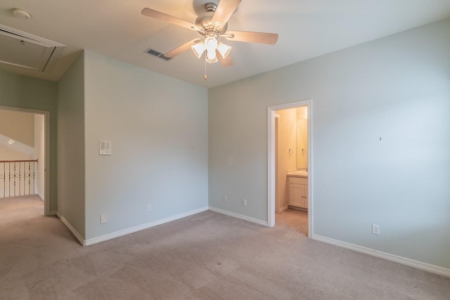 empty room featuring attic access, light carpet, ceiling fan, baseboards, and visible vents