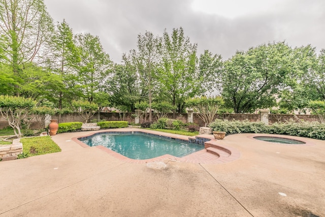 view of pool with a fenced backyard, a fenced in pool, an in ground hot tub, and a patio area