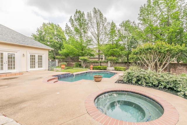 view of pool with a fenced backyard, french doors, an in ground hot tub, and a fenced in pool
