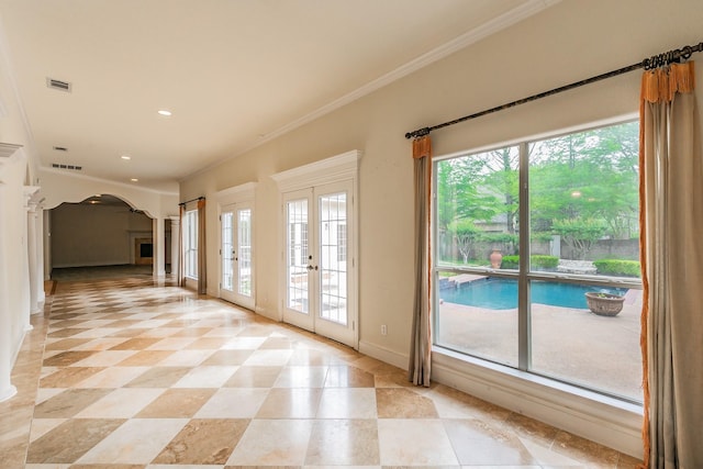 doorway featuring french doors, baseboards, visible vents, and arched walkways