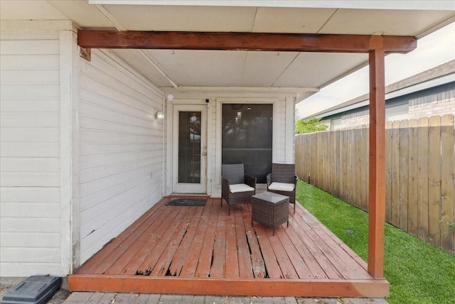 wooden terrace featuring fence