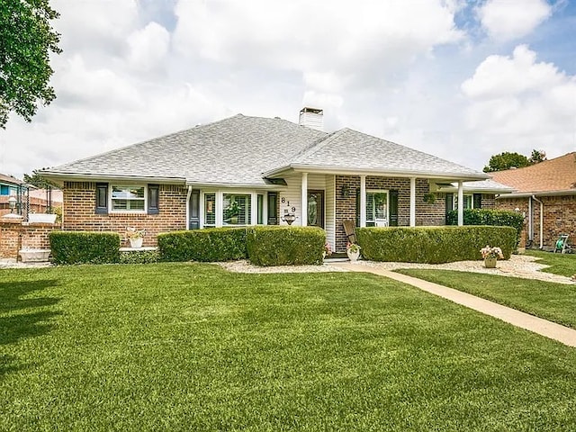 819 Meandering Way, Mesquite, TX 75150 - view of front of home with brick siding, a front yard, and a chimney