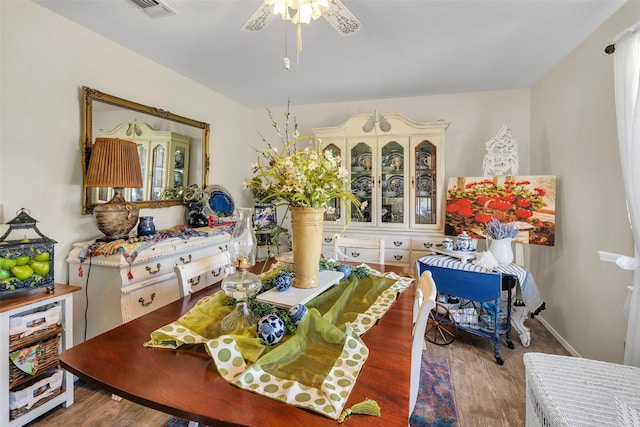 dining area featuring visible vents, ceiling fan, and wood finished floors