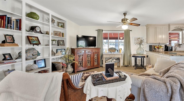 living room featuring ceiling fan, light wood-style floors, and plenty of natural light