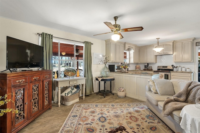 living room featuring ceiling fan and light wood-style flooring