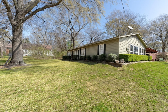 view of side of property with a lawn