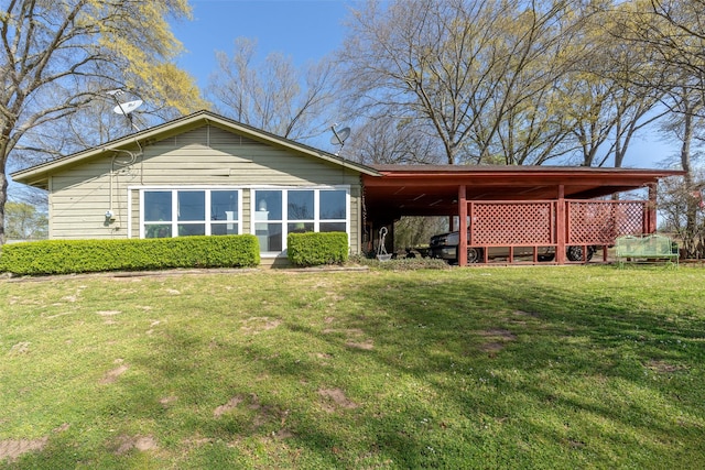 rear view of property featuring a lawn