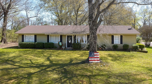 single story home with roof with shingles and a front yard