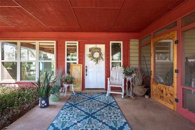 view of exterior entry featuring a porch