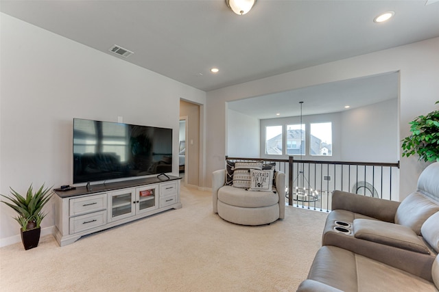 living area featuring recessed lighting, visible vents, baseboards, and light carpet