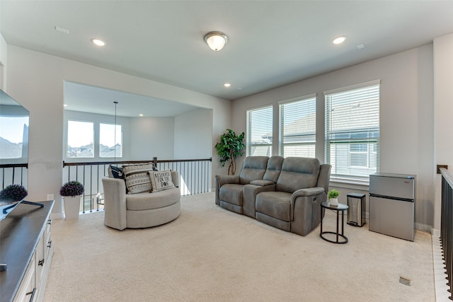 carpeted living area with recessed lighting