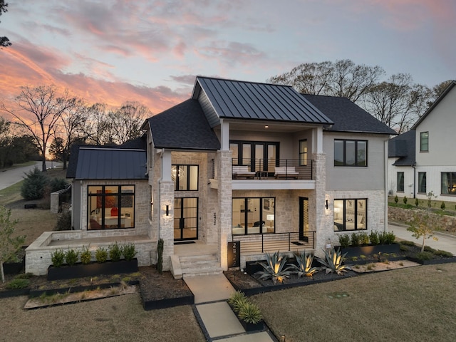2432 Bellview Cir, Tyler, TX 75709 - modern home featuring a balcony, a standing seam roof, stone siding, and metal roof