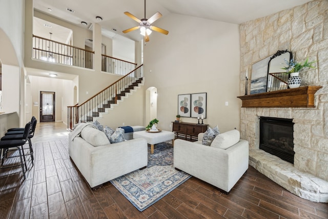 9721 Stripling Dr, Fort Worth, TX 76244 - living area featuring stairway, high vaulted ceiling, a ceiling fan, a stone fireplace, and dark wood-style floors